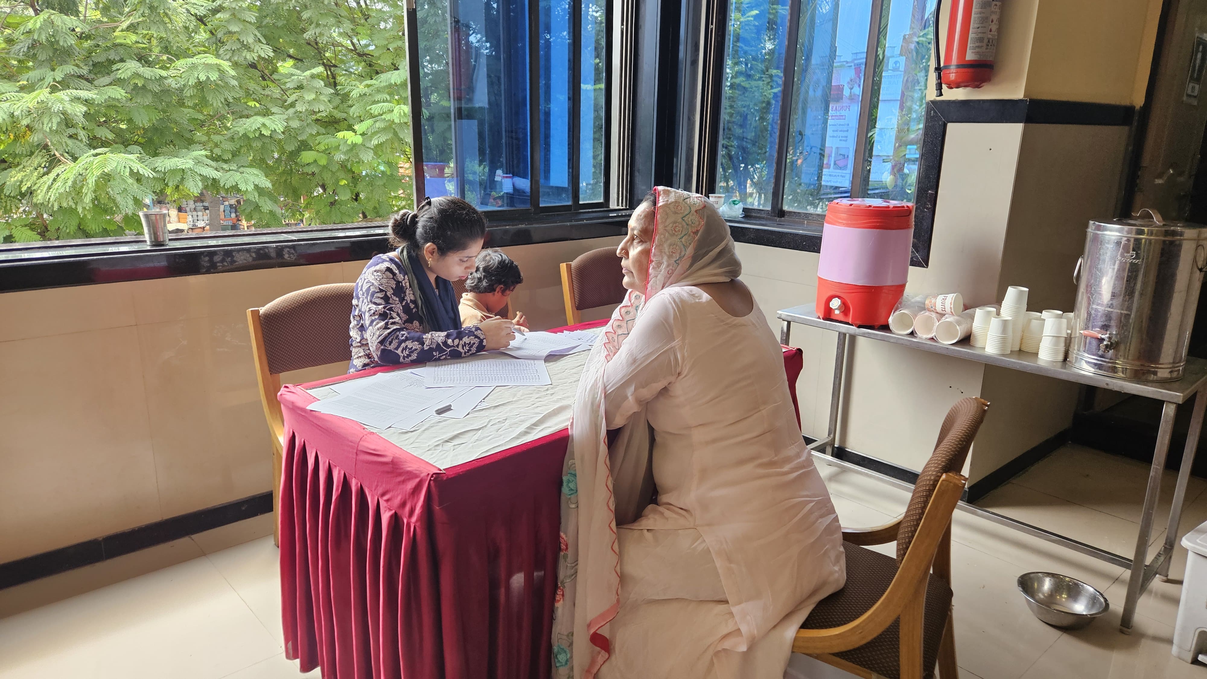 Attendee registering at the Health Checkup Camp in Vapi with blood testing